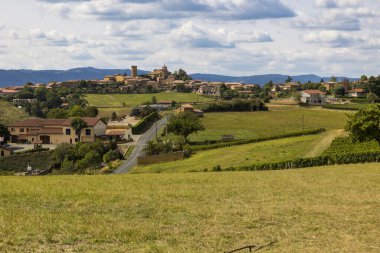 Medieval village of Oingt built in golden stones typical of this region of Beaujolais from the surrounding vineyards clipart