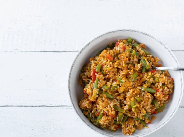 stock image Healthy brown  rice side dish on white background. Cooked with tomatoes, bell peppers, onions, garlic and green beans