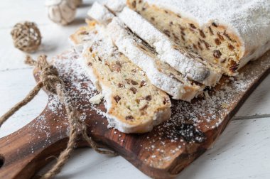 Loaf of fruit bread or fruit cake. Traditonal german christmas Stollen with candied fruits, raisins and nuts. Coated with powdered sugar.