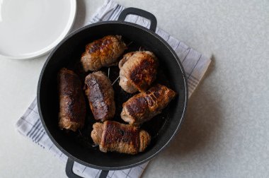 German Beef roulades fried in a roasting pan.Cooking, making, preparation. Part of a series