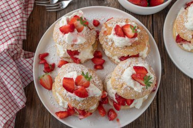 Strawberry shortcake on wooden table clipart