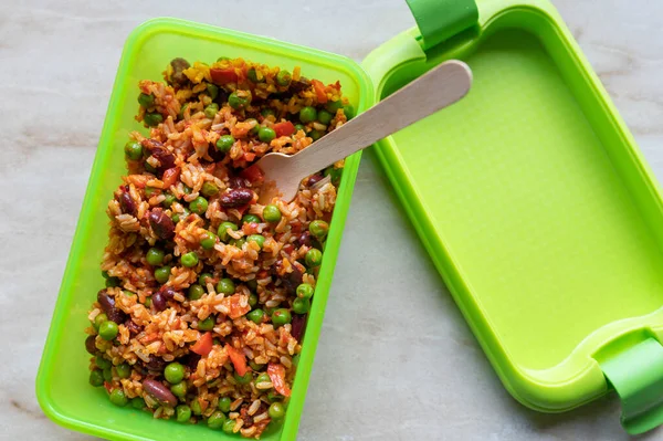 To go meal in a lunch box with mediterranean rice, vegetables and legumes. Vegetarian and zero waste