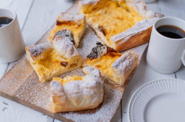 Puff pastry cake with delicious sour cream lemon filling on light background
