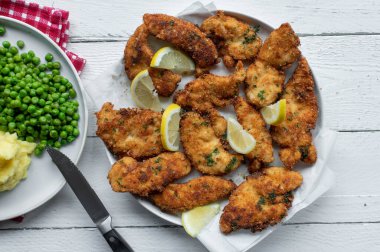 Parmesan crusted chicken breast on white background