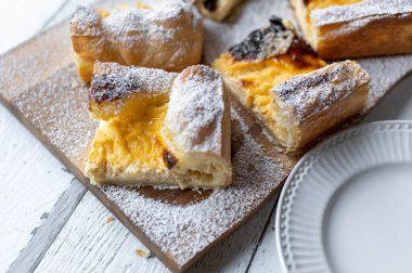 Puff pastry cake with delicious sour cream lemon filling on light background