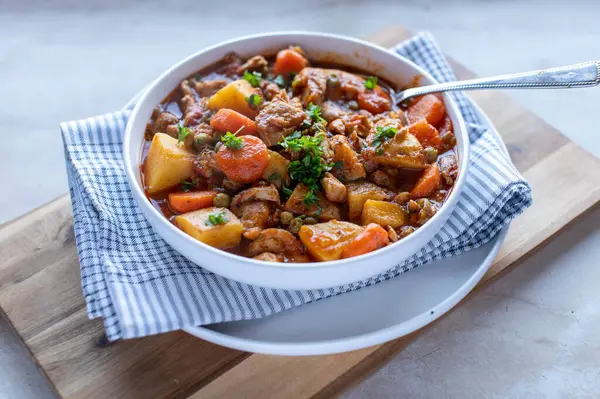 Homemade healthy vegetable stew or soup with chicken meat, carrots, potatoes, tomatoes, onion, herbs and garlic. Healthy eating meal. Gluten free dinner