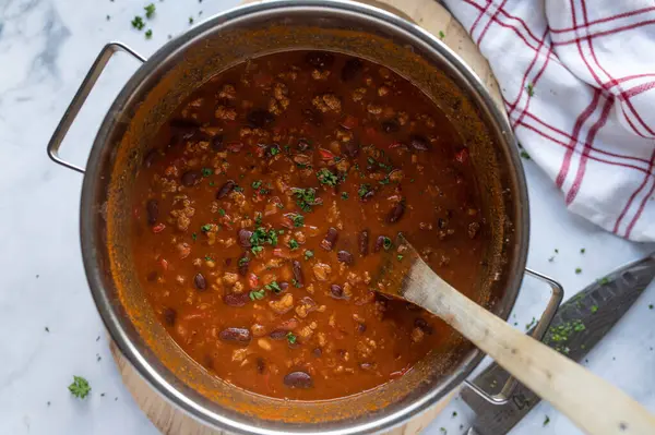 Healthy low fat bean soup in a pot. Cooked with kidney beans, lean ground beef, vegetables suchas tomatoes, chili, peppers, onions, garlic and herbs