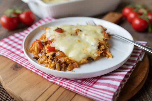 stock image Pasta casserole with greek kritharaki, tomatoes, peppers, onions, garlic and melted mozzarella cheese fresh and homemade cooked