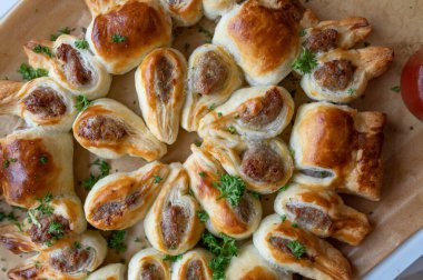 Puff pastry filled with bratwurst or fried sausage and served as a party wreath clipart