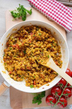 Pirinç ve sebzeli nohut körisi. Taze ve ev yapımı. Dekore edilmiş arka planda kızartma tavasında pişirilmiş.