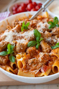 Pasta with delicious fried sausage balls in tomato sauce with parmesan cheese