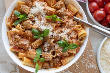 Pasta with delicious fried sausage balls in tomato sauce with parmesan cheese