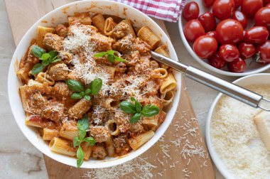 Pasta with delicious fried sausage balls in tomato sauce with parmesan cheese