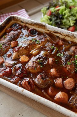 Oven braised chicken breast with delicious sauce and vegetables in a casserole dish