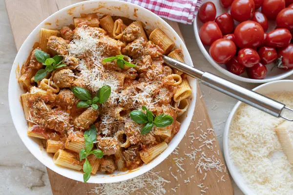 Pasta with delicious fried sausage balls in tomato sauce with parmesan cheese