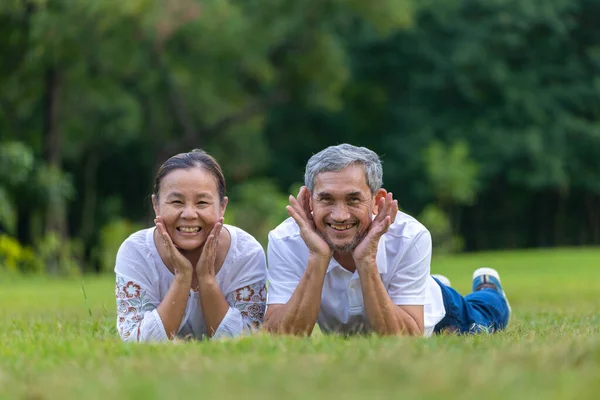 Portrait Senior Asian Couple Lying Grass Public Park Looking Camera — Stock Photo, Image