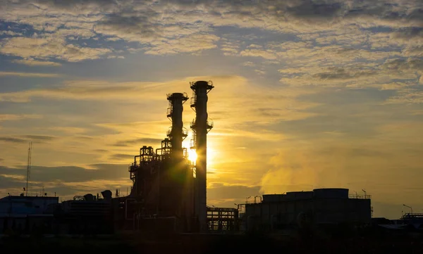 Silhouette of gas turbine power plant at sunset which create pollution and global warming cause ozone layer depletion for electricity and energy
