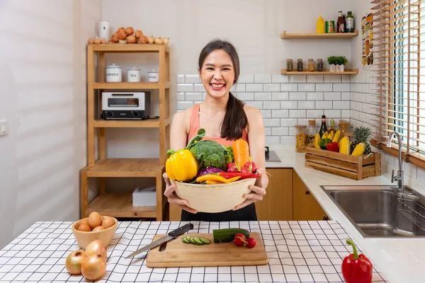 Asian housewife is showing variety of organic vegetables to prepare simple and easy japanese dish to cook salad meal for vegan and vegetarian soul food
