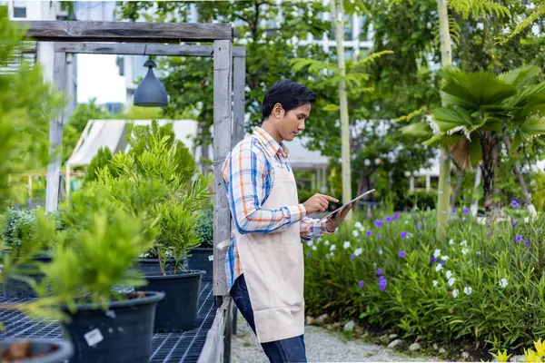 Asian Gardener Using Digital Tablet While Working His Nursery Garden — Stock Photo, Image