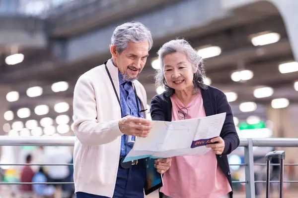 Asian Active Senior Retirement Couple Looking Map Direction Airport Terminal — Stock Photo, Image
