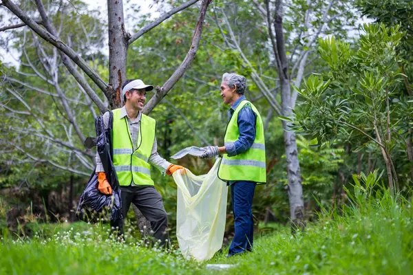 Stock image Team volunteer worker group enjoy charitable social work outdoor in cleaning up garbage and waste separation project at the park or natural forest for community service and recycle