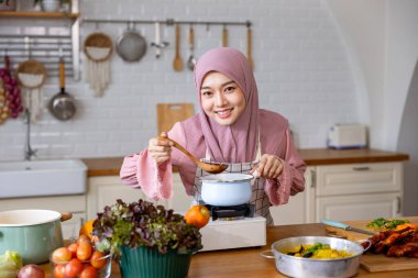 Mutlu Arap Müslüman ev hanımı, Orta Doğu 'daki evde lezzetli helal yemekler ve Ramazan ayından sonra bayram bayramı için İran mutfağı yemeği hazırlıyor ve pişiriyor.