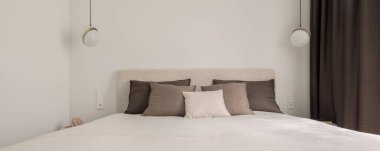 Modern minimalist yatak odası iç tasarımı kahverengi ve beyaz tonlarda