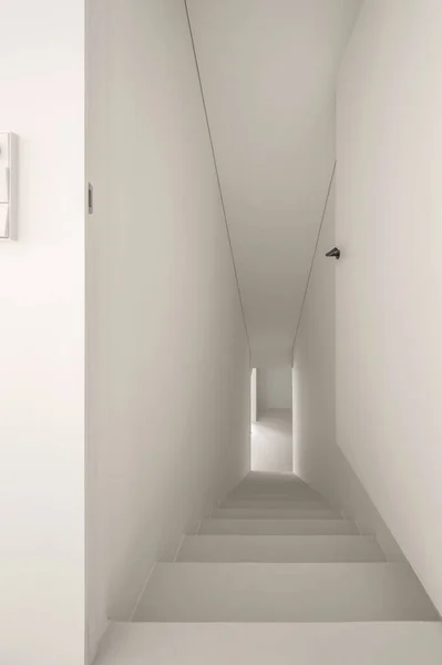 Opened white door and minimalistic white stairs