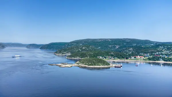 stock image Aerial view of Tadoussac bay and Saguenay Fjord taken by drone over the St-Lawrence river. View of the Baie-Ste-Catherine, Tadoussac ferry crossing the Saguenay river and Pointe-de-L'Islet trail.