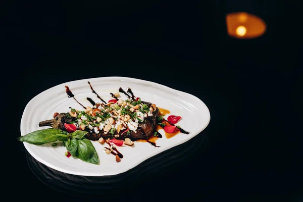 stock image Eggplant stuffed with feta, nuts and green onions, decorated with balsamic sauce.