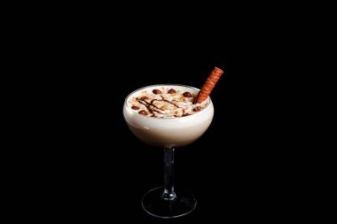 Karamelli milkshake, krema likörü, siyah arka planda çikolata tozu..