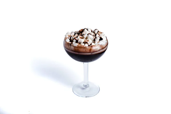 Chocolate shake with dripping sauce and marshmallows. On white background.