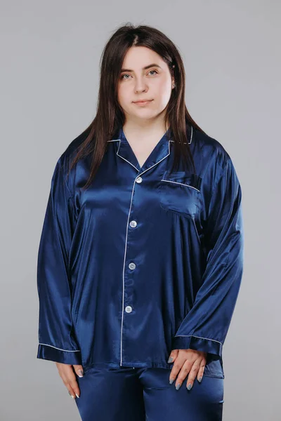 fat pretty smiling girl in blue pajamas. catalog photo. home response concept