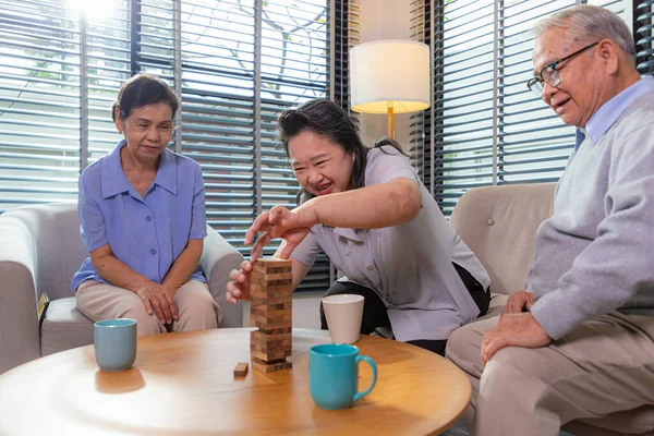 Elderly Friends Building Tower Wooden Cubes Leisure Time Nursing Home — Stock Photo, Image