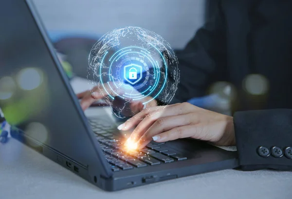 Woman hands working on computer and lock hologram drawing in the world cyber. Security concept.