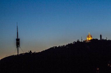 Barselona 'nın Tibidabo Dağı' nın Turo de la Rovira adlı tepeden çekilmiş gece manzarası. Yazın başında gün batımı.