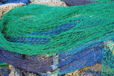 Close-up of tangled green fishing nets with yellow buoys, highlighting maritime equipment texture and detail. clipart