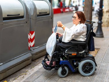 Woman in a wheelchair throws away trash at a recycling point, emphasizing inclusivity and city accessibility. clipart