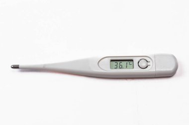 Digital thermometer displaying a temperature reading of 36.1 C, placed on a white surface. clipart