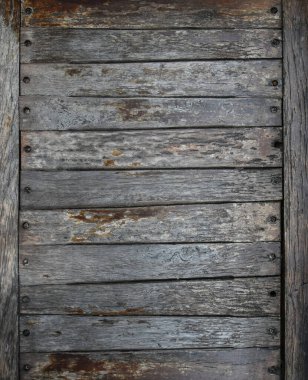 Close up background of old vintage weathered wooden planks or logs panel with paint scaling, abandoned and run down