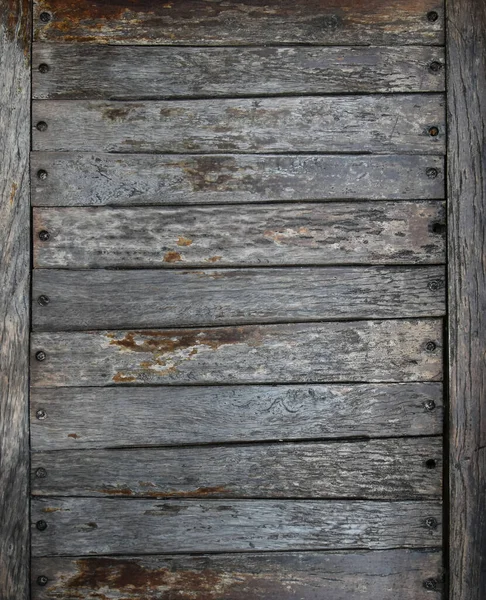 Close up background of old vintage weathered wooden planks or logs panel with paint scaling, abandoned and run down