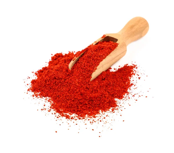 stock image Close up one wooden scoop full of red chili pepper, paprika or sundried tomato powder spilled and spread around isolated on white background, high angle view