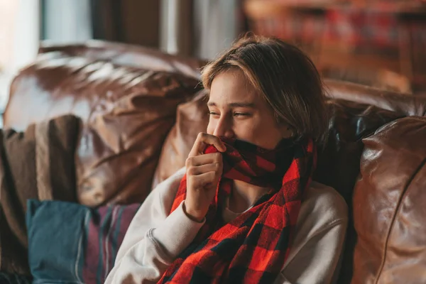 stock image Young emotional cheerful teen boy with long hair laughter and joyful at cozy home. Stylish zoomer gen Z in good mood celebrates new year holidays with xmas tree bokeh lights garlands eve 25 december