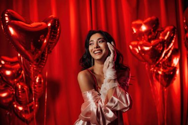 Japanese woman wearing sexy lace underwear posing on red glamour background 