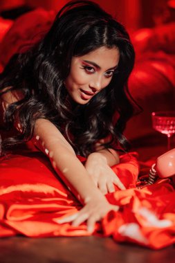 Curly black hair asian model posing in bed on Valentine's day