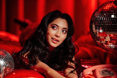 Close up portrait of curly black hair asian model posing in bed on Valentine's day