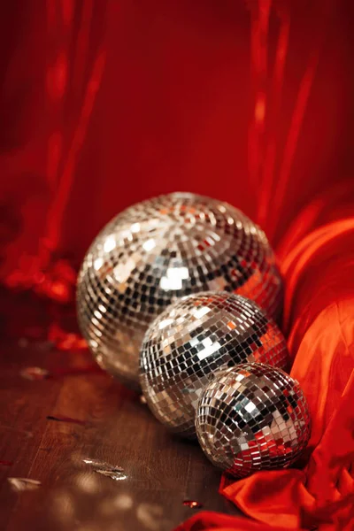 Glossy mirror balls in extravagant atmosphere interior decoration at vivid red background glamour. Beautiful place for saint valentines holiday with disco balls in romantic burlesque bedroom