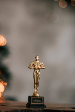 Hollywood altın Oscar ödüllü biblo taklidi bir ödül töreni sırasında görüldü. Başarı ve zafer konsepti parlak sarı ışıklar arka planında heykelciği kapatın