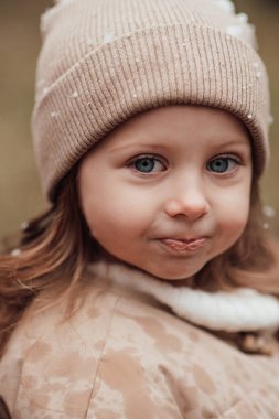 Noel 'i ve yeni yılı kutlayan bayan çocuk kış tatilini dışarıda kutluyor. Aktif küçük kız kozalaklı ormanda çocukluğunun tadını çıkarıyor.