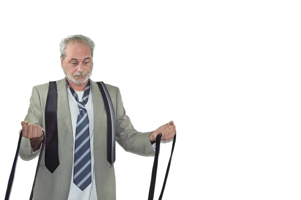 mature man with beard in a suit looking many ties standing on a white background